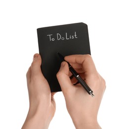 Photo of Woman filling To Do list in notepad on white background, closeup