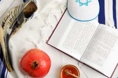 Photo of Flat lay composition with Rosh Hashanah holiday symbols on fabric