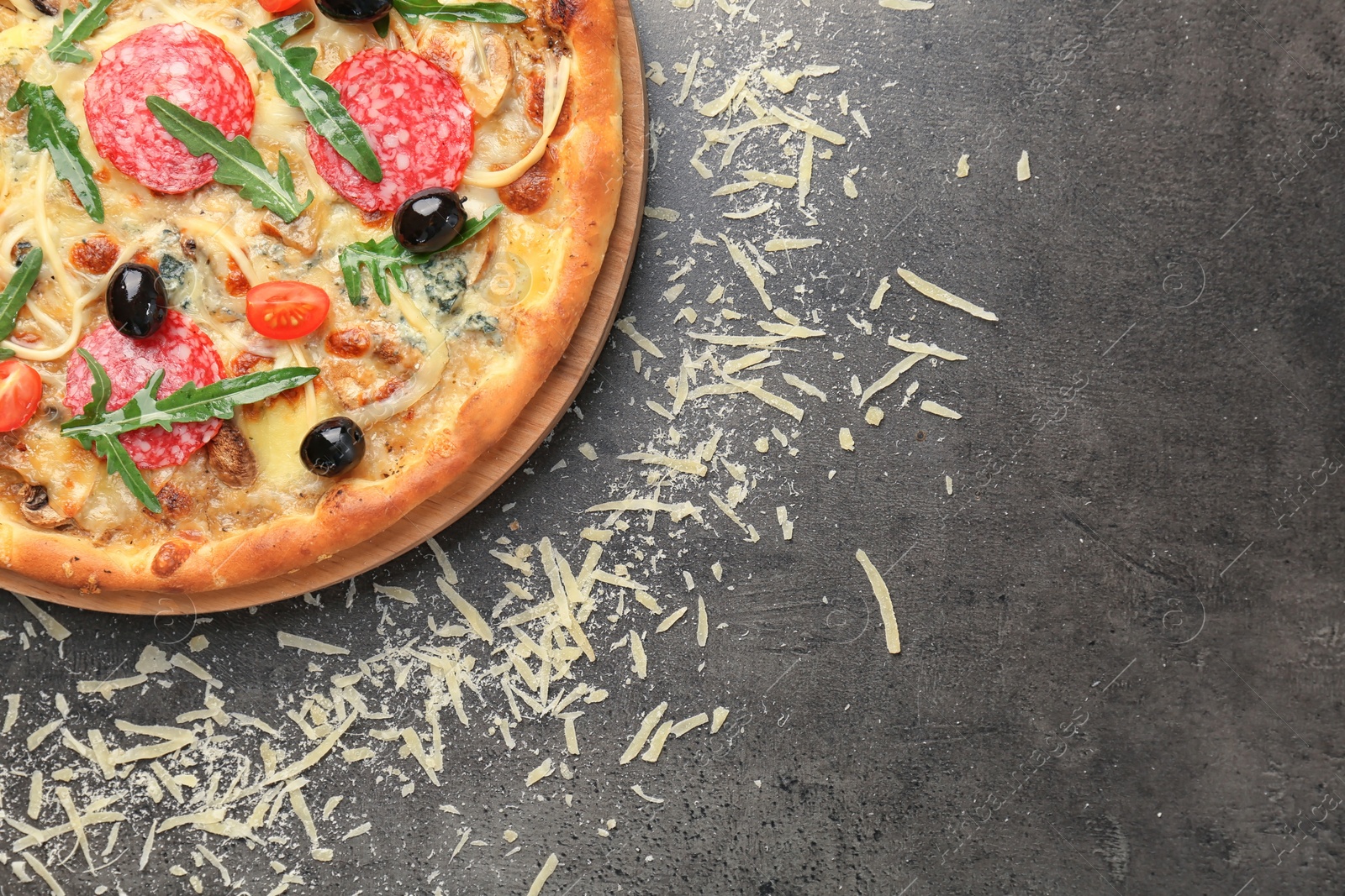 Photo of Delicious pizza with tomatoes and sausage on table, top view