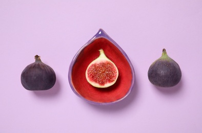 Photo of Flat lay composition with ripe fig fruits on pink background