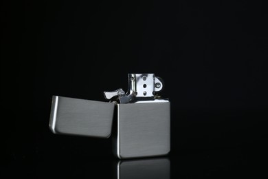 Photo of Gray metallic cigarette lighter on black background