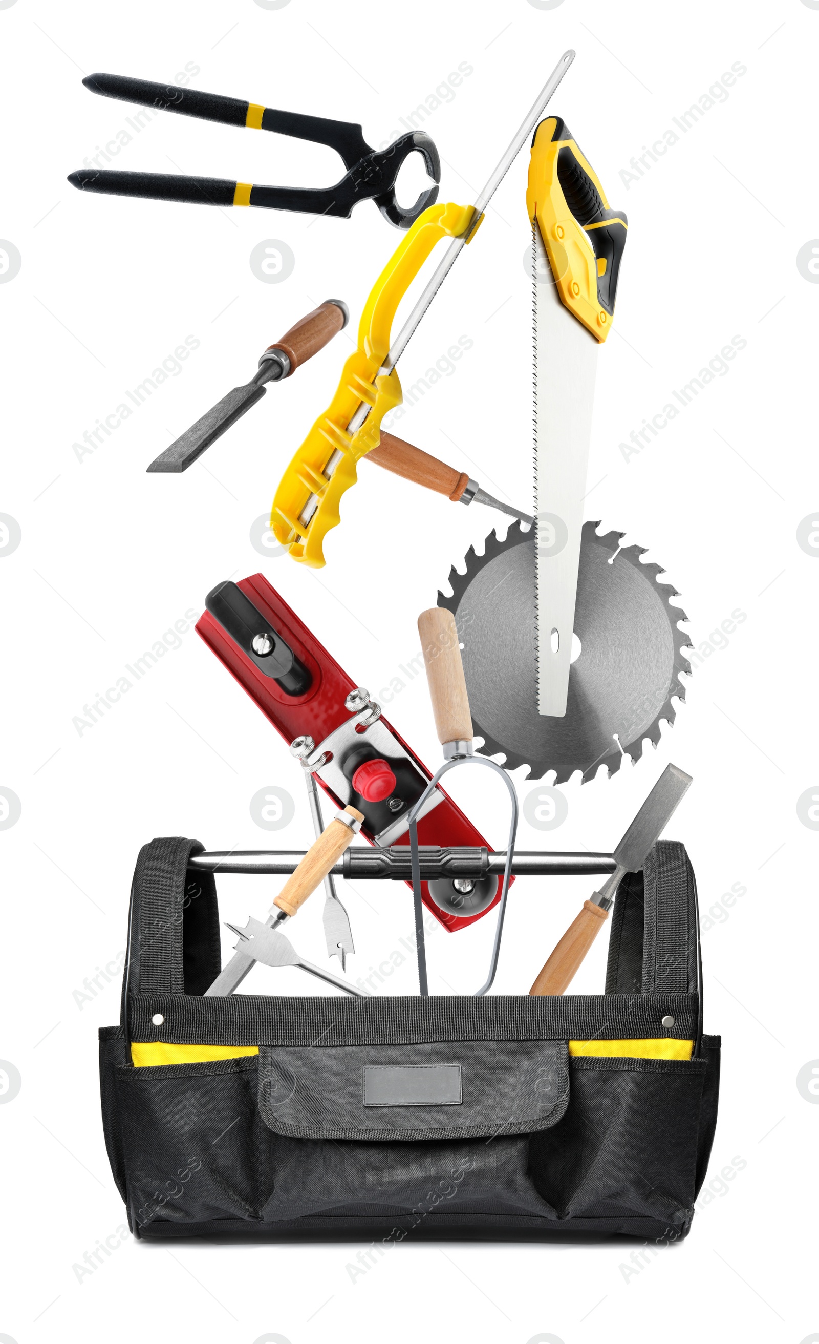 Image of Different carpenter's tools falling into bag on white background