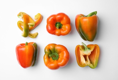 Flat lay composition with raw ripe paprika peppers on white background