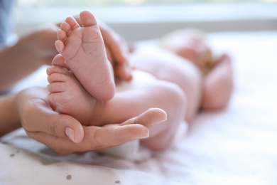 Photo of Mother and her newborn baby on bed, closeup. Space for text