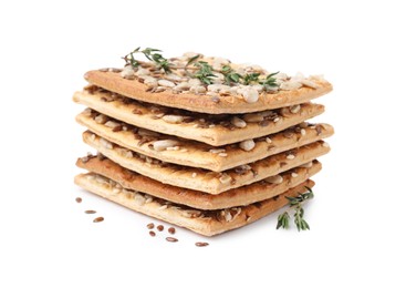 Photo of Stack of cereal crackers with flax, sunflower, sesame seeds and thyme isolated on white