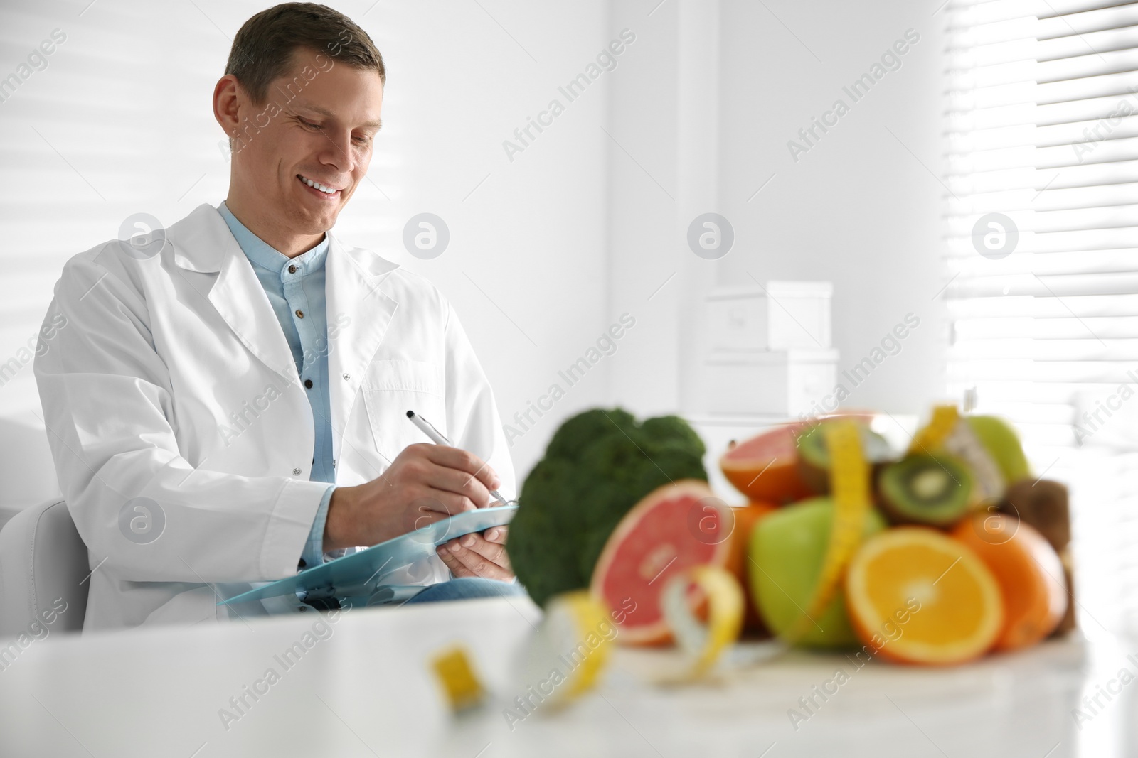 Photo of Nutritionist working at desk in his office