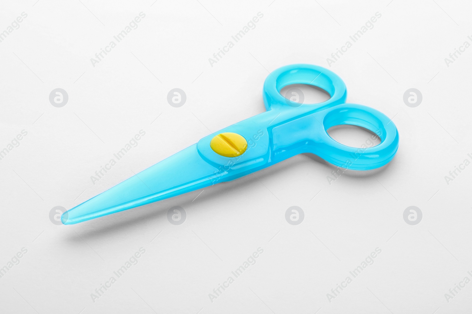 Photo of Colorful plastic scissors on white background. School stationery