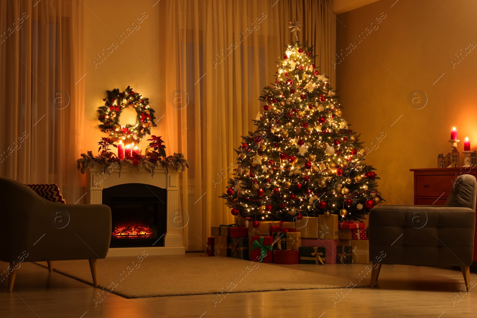 Photo of Beautiful Christmas tree and gifts near fireplace in festively decorated living room