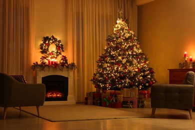 Beautiful Christmas tree and gifts near fireplace in festively decorated living room