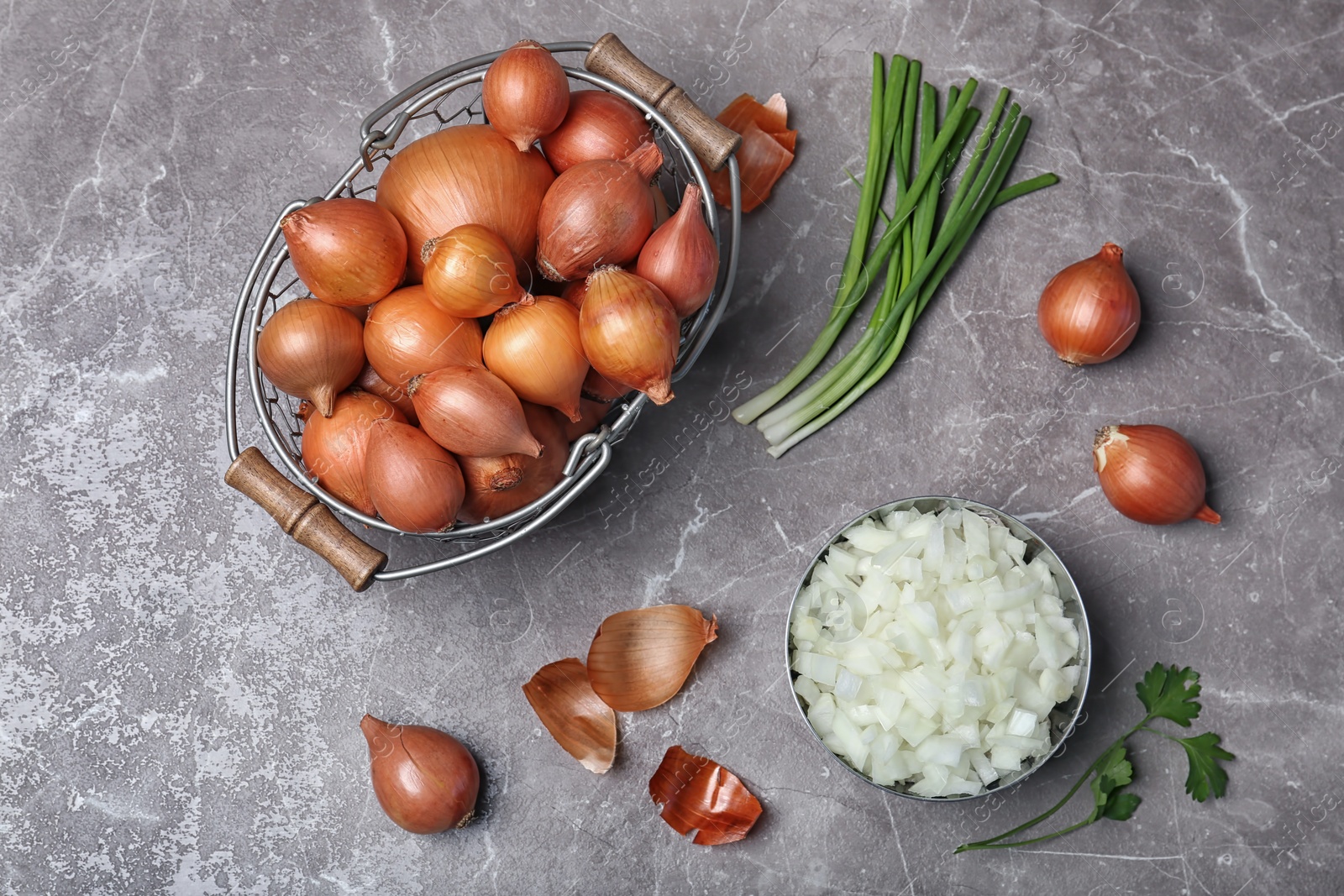 Photo of Flat lay composition with ripe onions on grey background