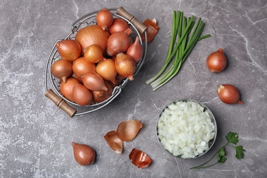 Flat lay composition with ripe onions on grey background