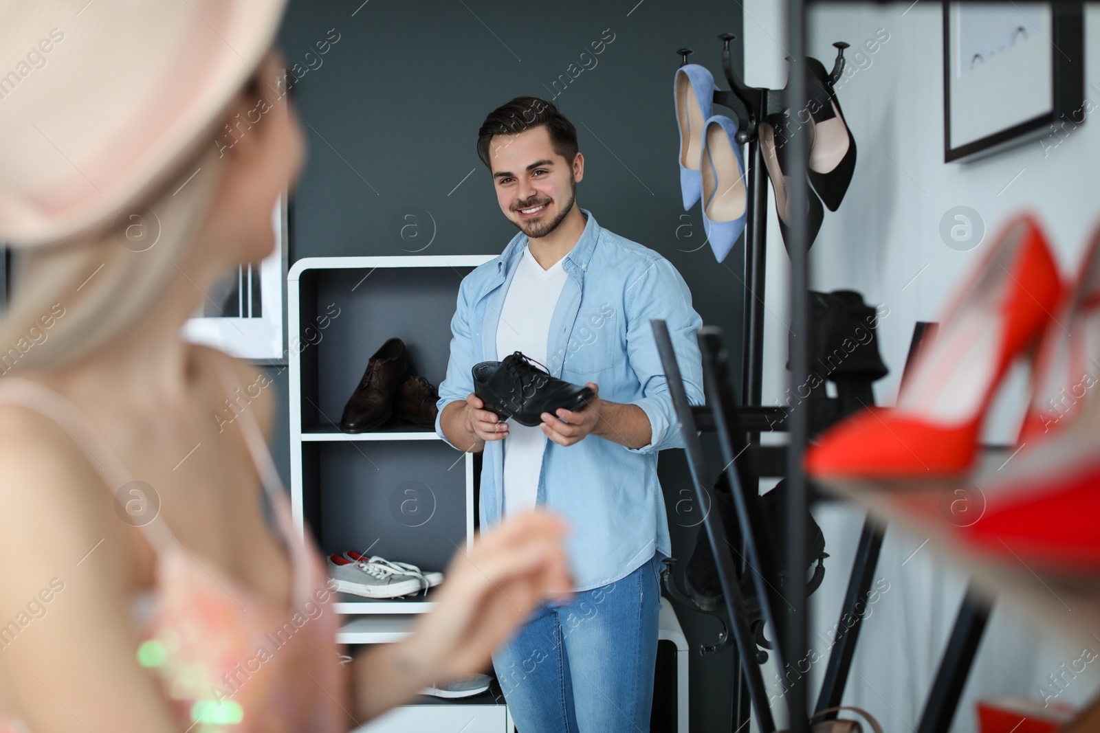 Photo of Young man choosing shoes in store