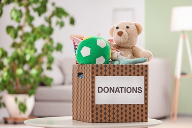 Photo of Donation box with toys on table indoors