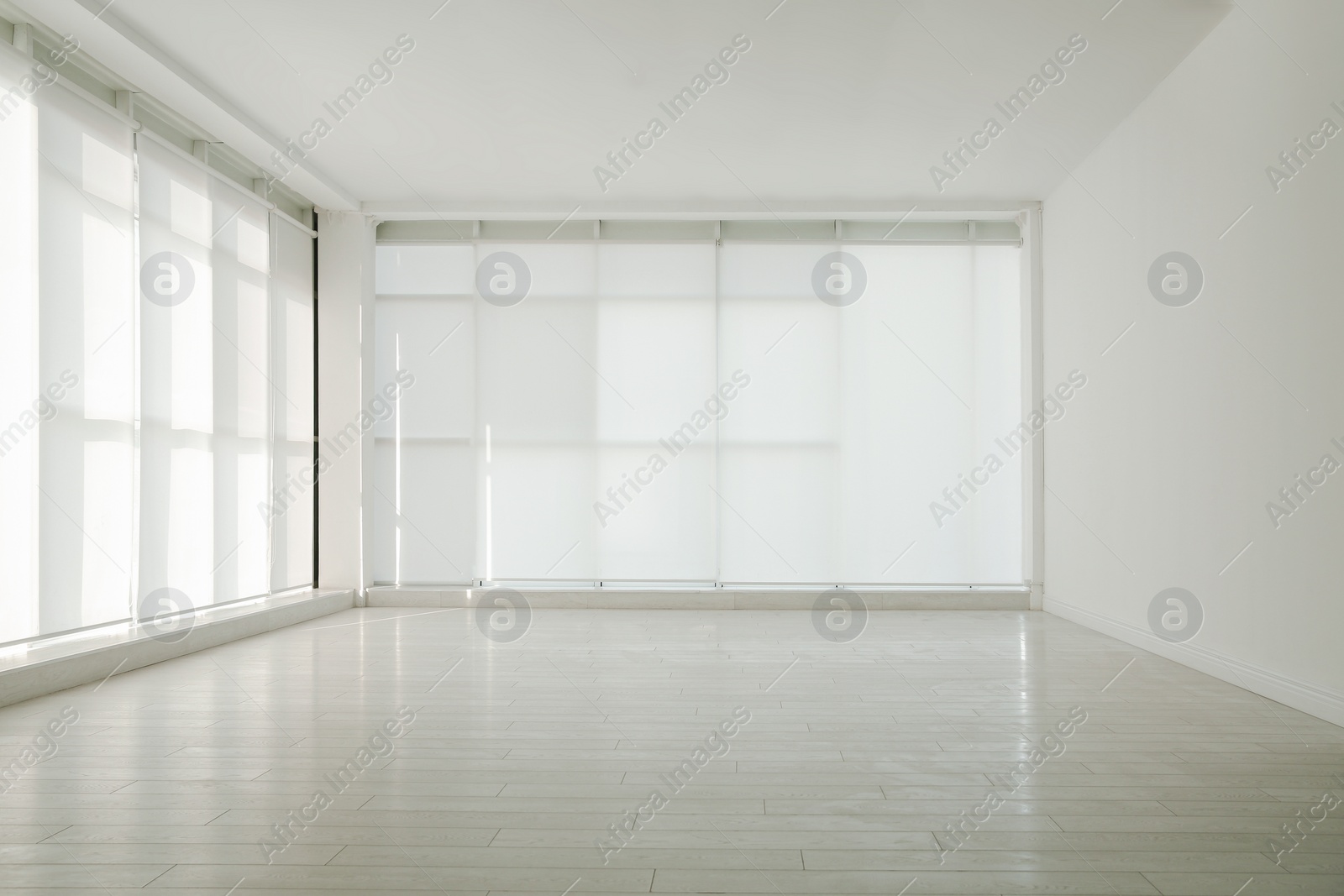 Photo of Empty room with panoramic windows and white wooden floor