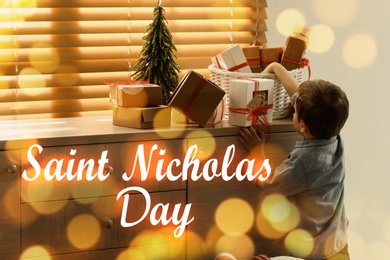 Image of Saint Nicholas Day. Little boy with gifts at home