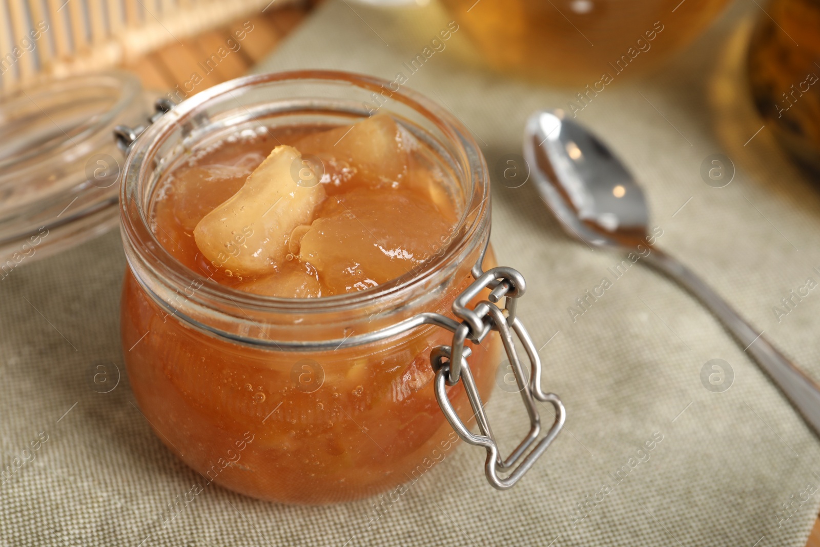 Photo of Delicious apple jam in jar on table, closeup
