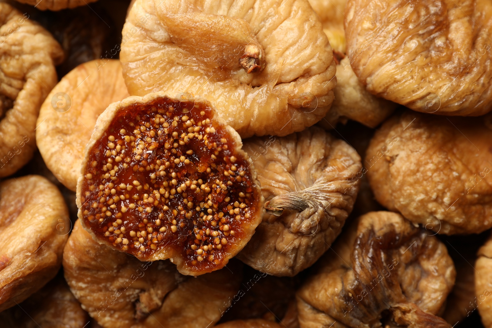 Photo of Many tasty dried figs as background, top view