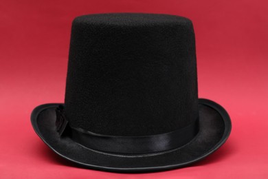 Photo of One magician top hat on red background