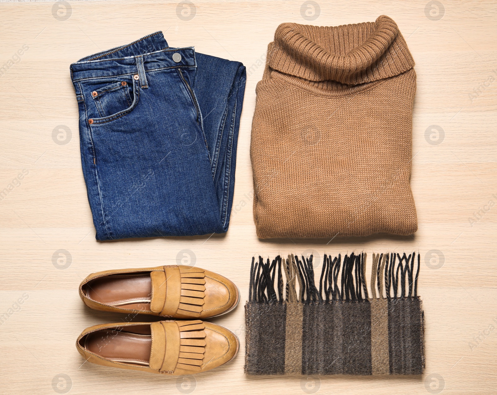 Photo of Flat lay composition with stylish clothes and shoes on wooden background