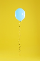 Photo of Bright balloon on color background. Celebration time