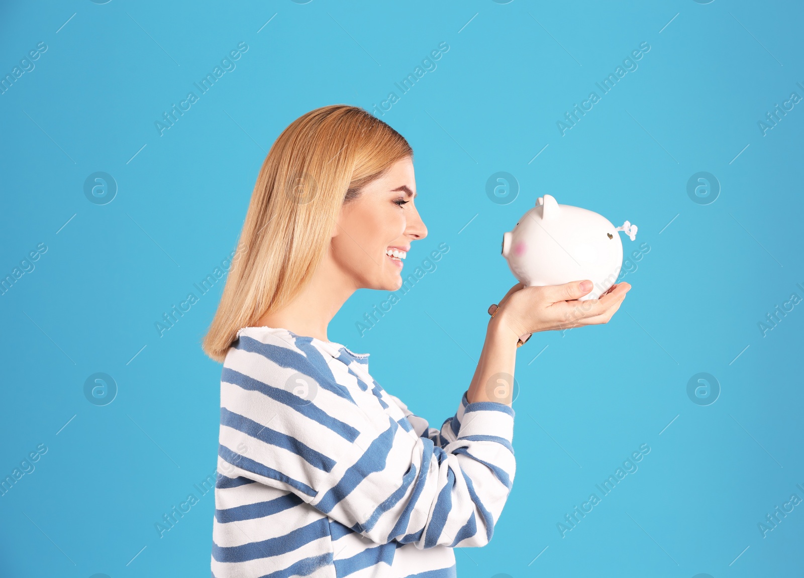 Photo of Woman with piggy bank on color background