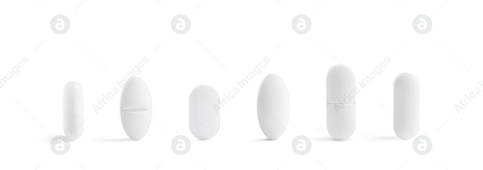 Image of Set of different pills in row isolated on white