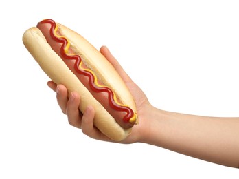 Photo of Woman holding delicious hot dog with mustard and ketchup on white background, closeup