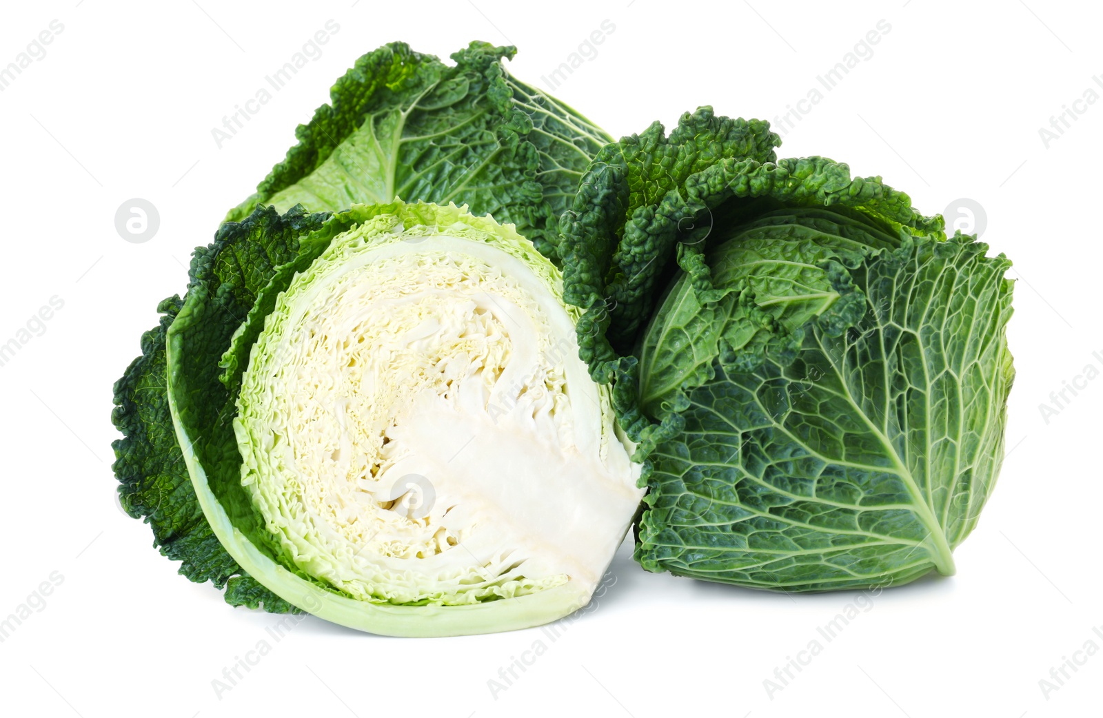 Photo of Whole and cut fresh savoy cabbages on white background