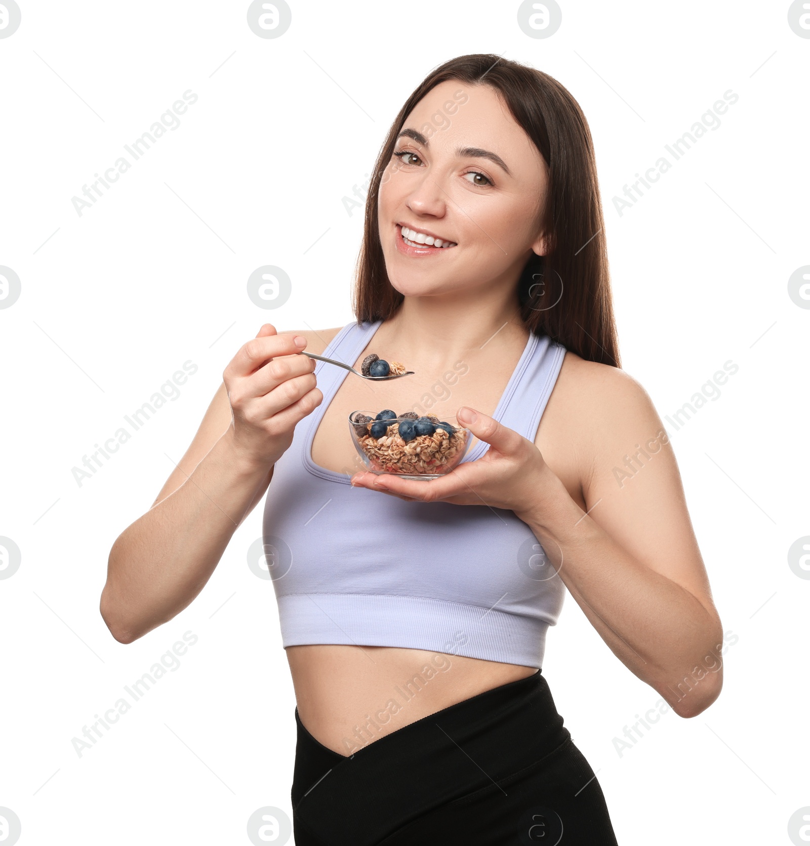 Photo of Happy woman eating tasty granola with fresh berries on white background