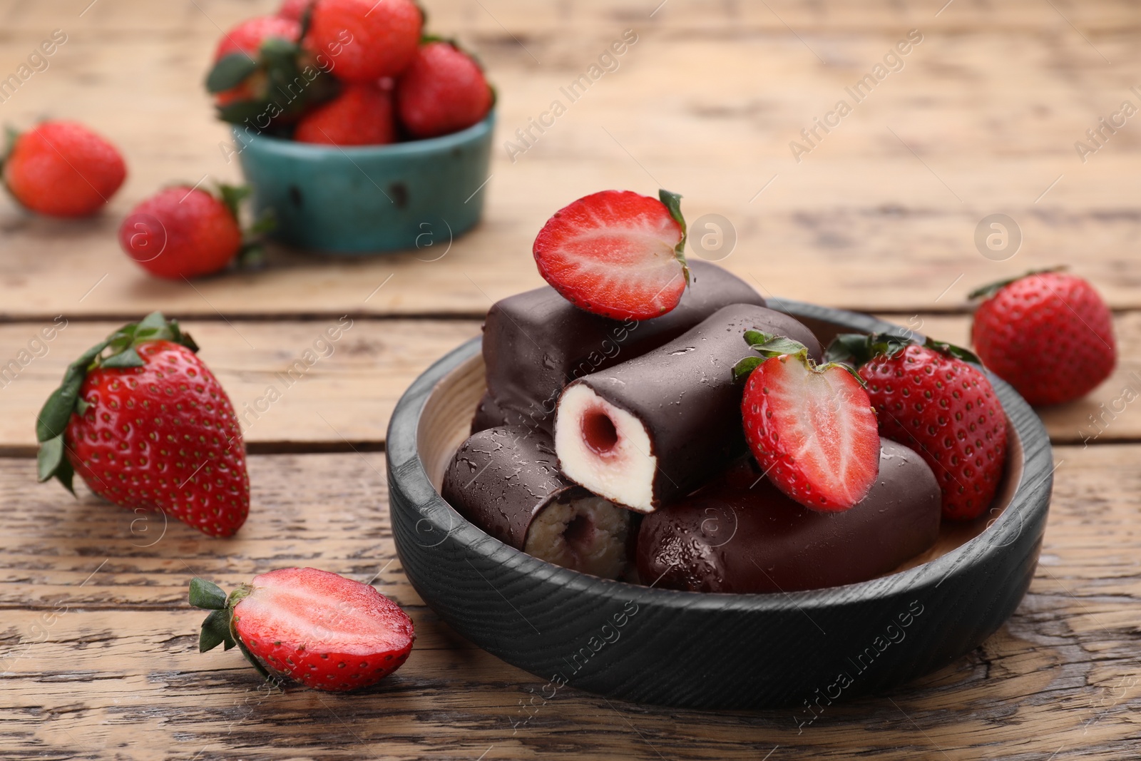 Photo of Delicious glazed curd snacks with fresh strawberries and mint on wooden table