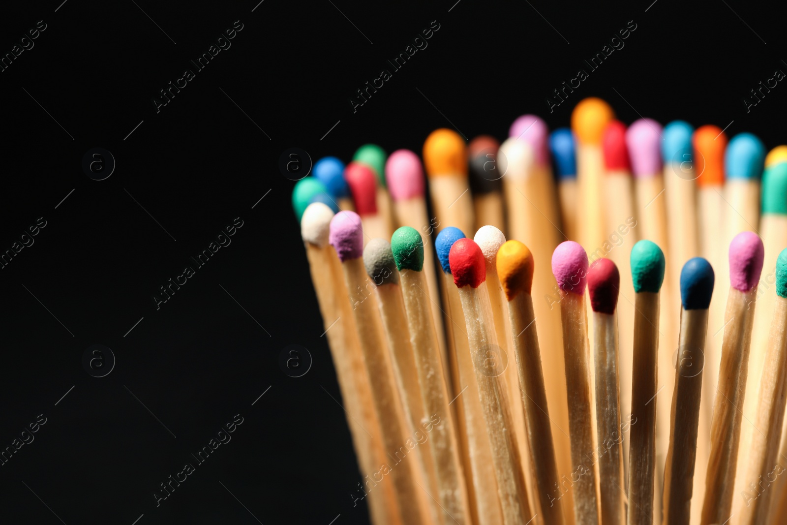 Photo of Matches with colorful heads on black background, closeup. Space for text