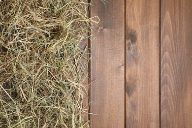 Photo of Dried hay on wooden table, top view. Space for text