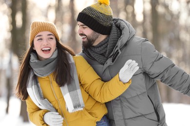 Happy young couple having fun outdoors on winter day