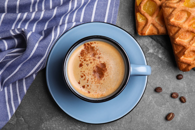 Photo of Delicious coffee and pastries on grey table, flat lay