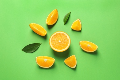 Flat lay composition with ripe oranges on color background