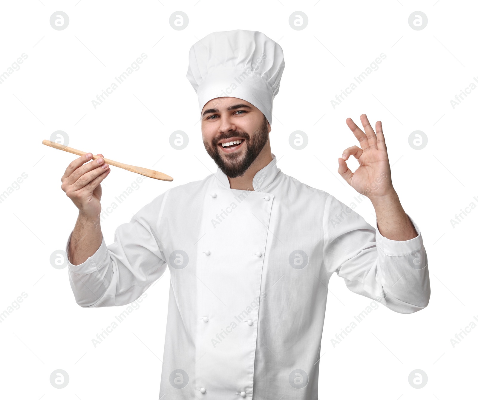 Photo of Happy young chef in uniform tasting something and showing ok gesture on white background