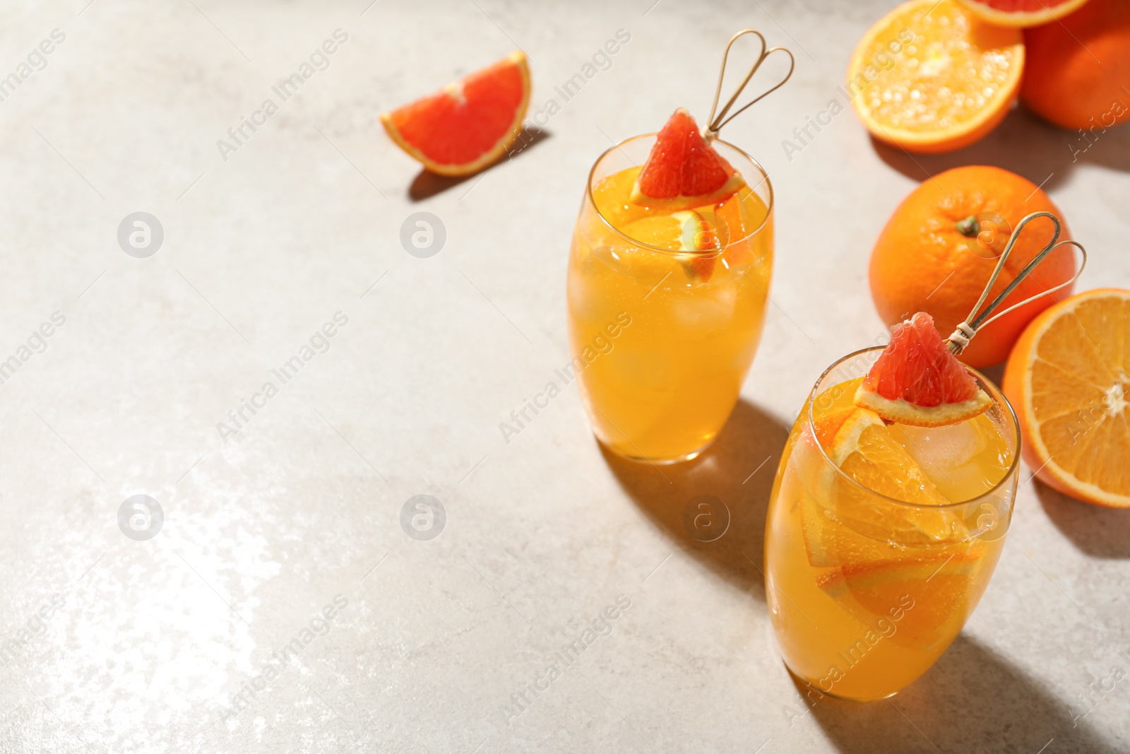 Photo of Delicious orange soda water on light table. Space for text