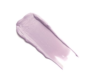 Stroke of purple color correcting concealer on white background, top view