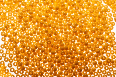 Photo of Pile of orange beads as background, closeup