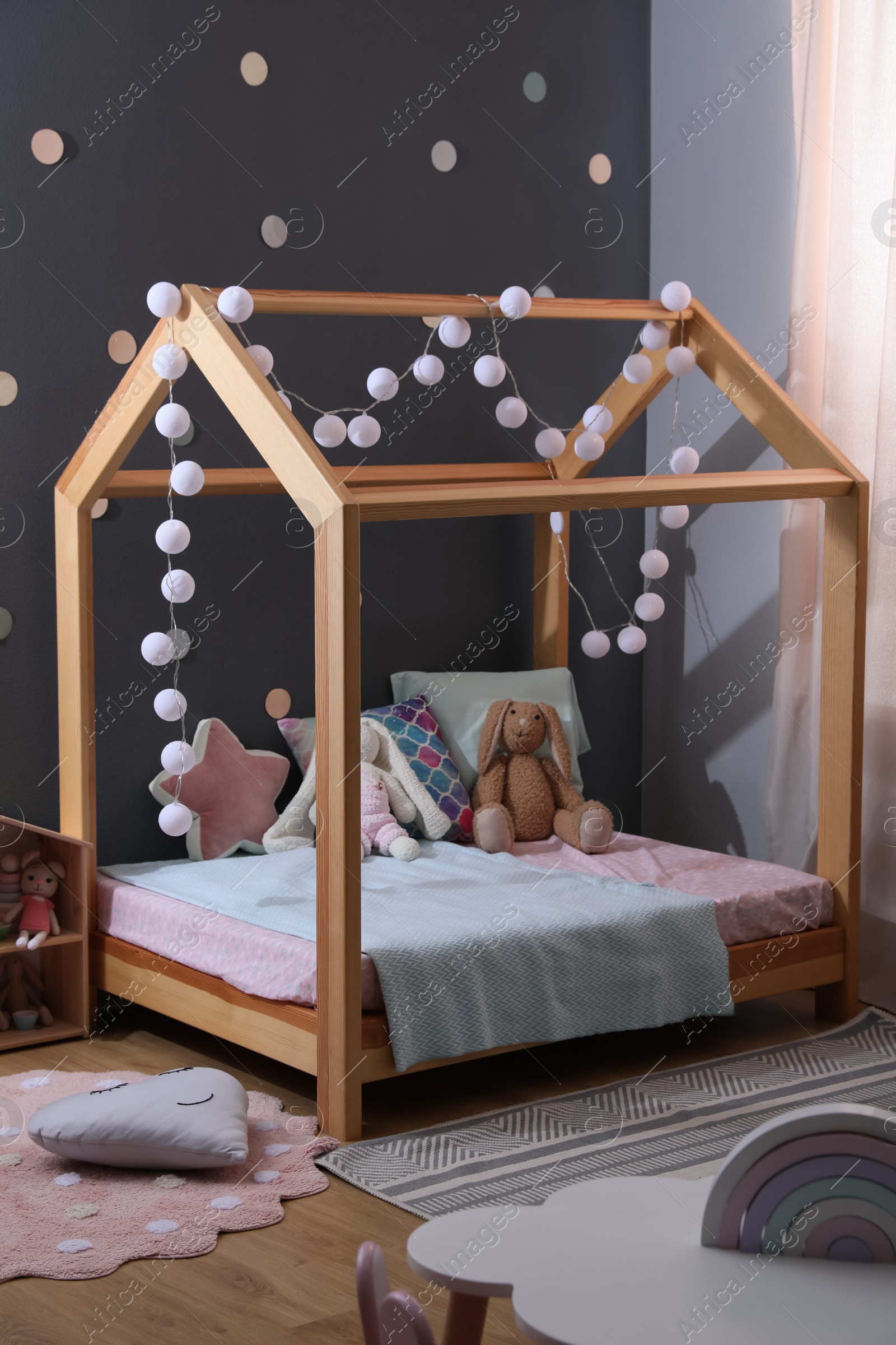 Photo of Stylish child room interior with comfortable bed