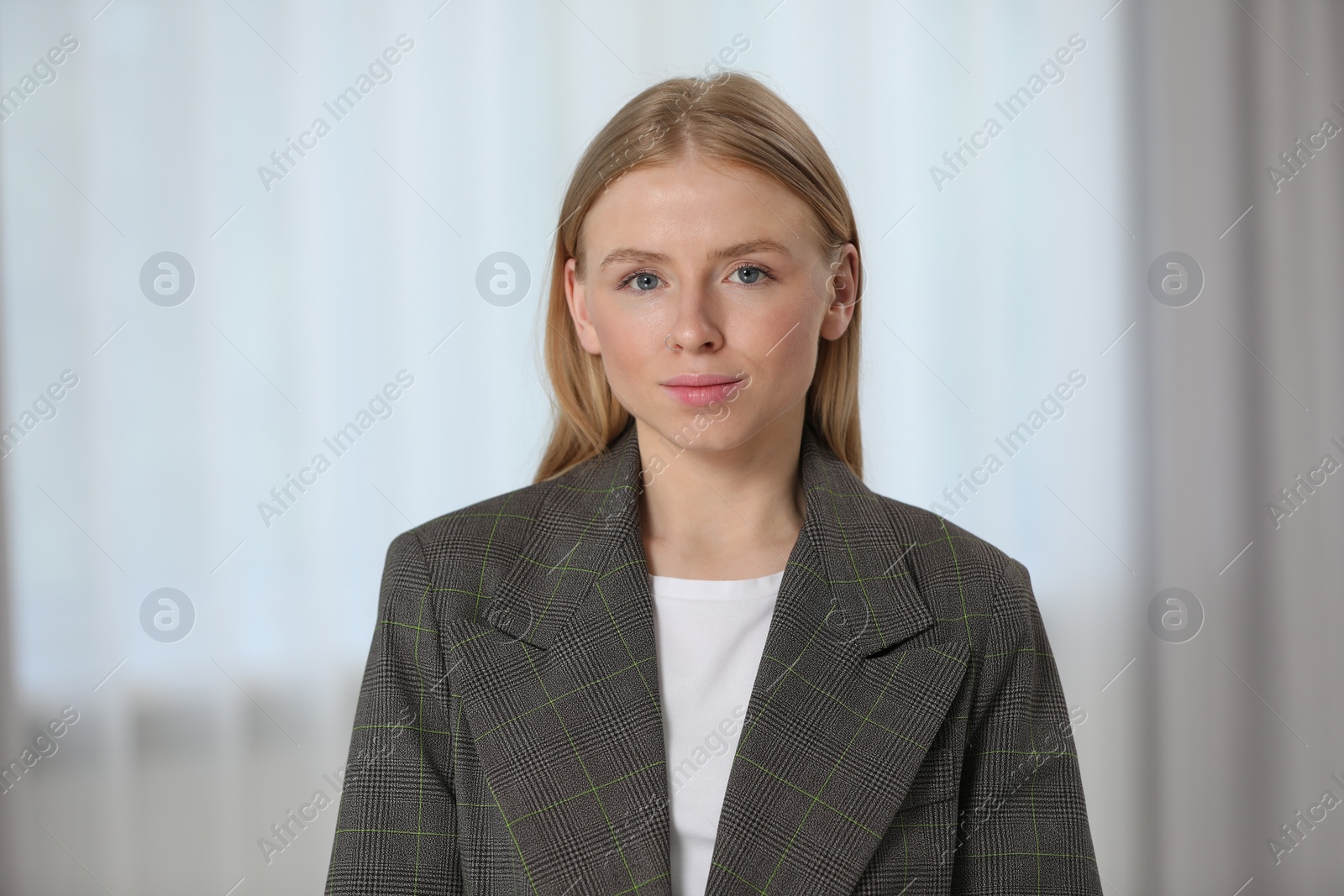 Photo of Portrait of beautiful young woman in stylish jacket indoors