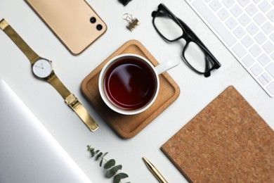 Photo of Flat lay composition with ceramic mug of aromatic tea and glasses on white background