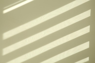 Photo of Lines made of light and shadows on white wall