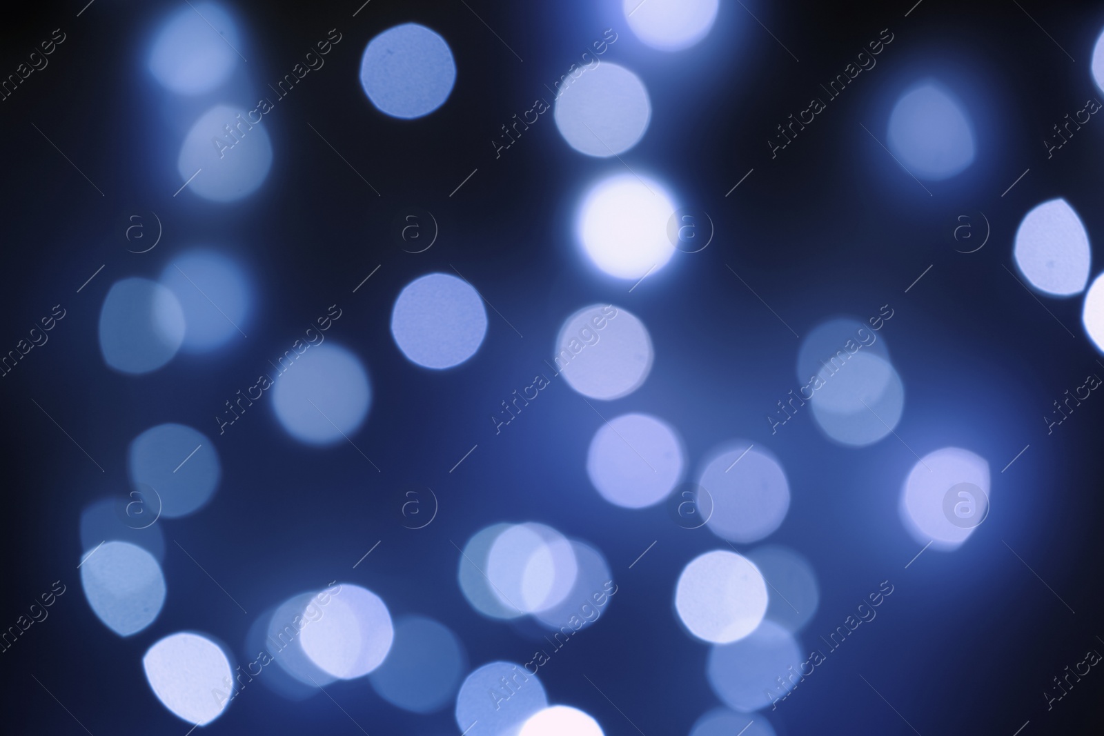 Photo of Blurred view of beautiful lights on dark background