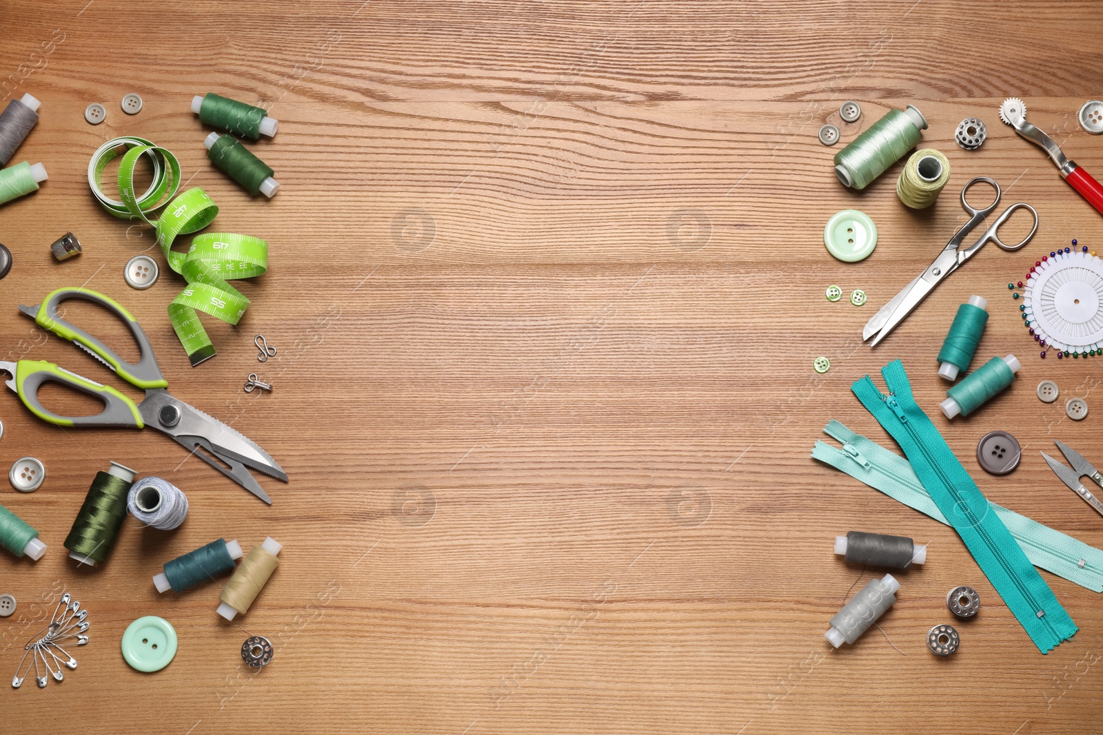 Photo of Flat lay composition with different sewing accessories on wooden background. Space for text