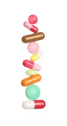 Photo of Stack of different colorful pills on white background