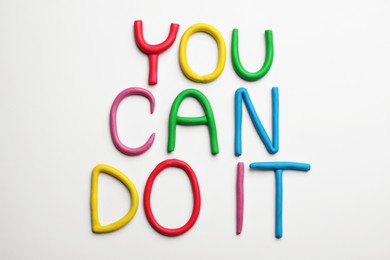 Photo of Motivational phrase You Can Do IT made of colorful plasticine on white background, flat lay