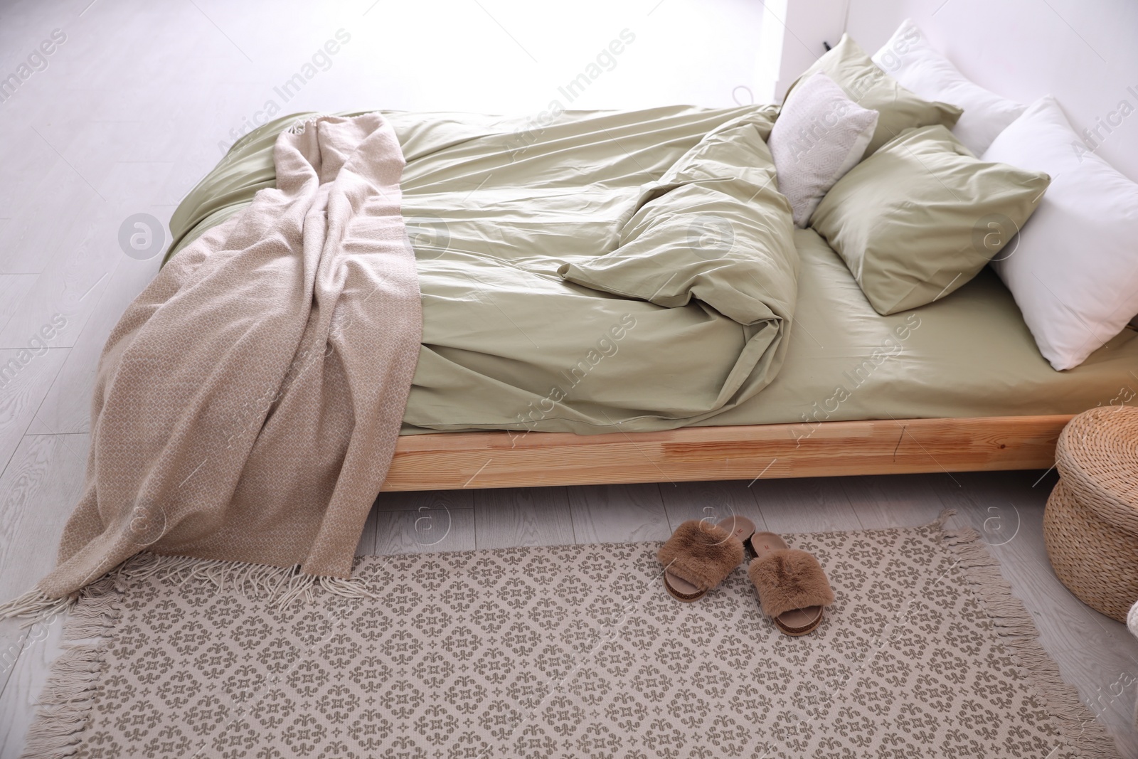 Photo of Comfortable bed with olive green linen in modern room interior