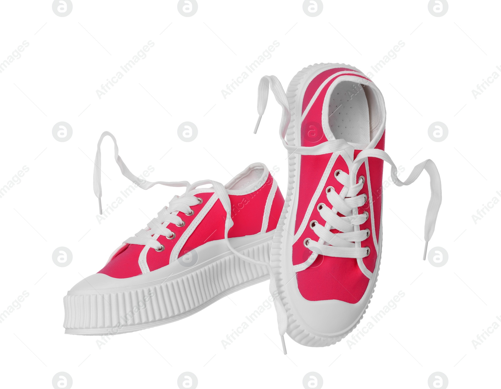 Photo of Pair of red classic old school sneakers on white background