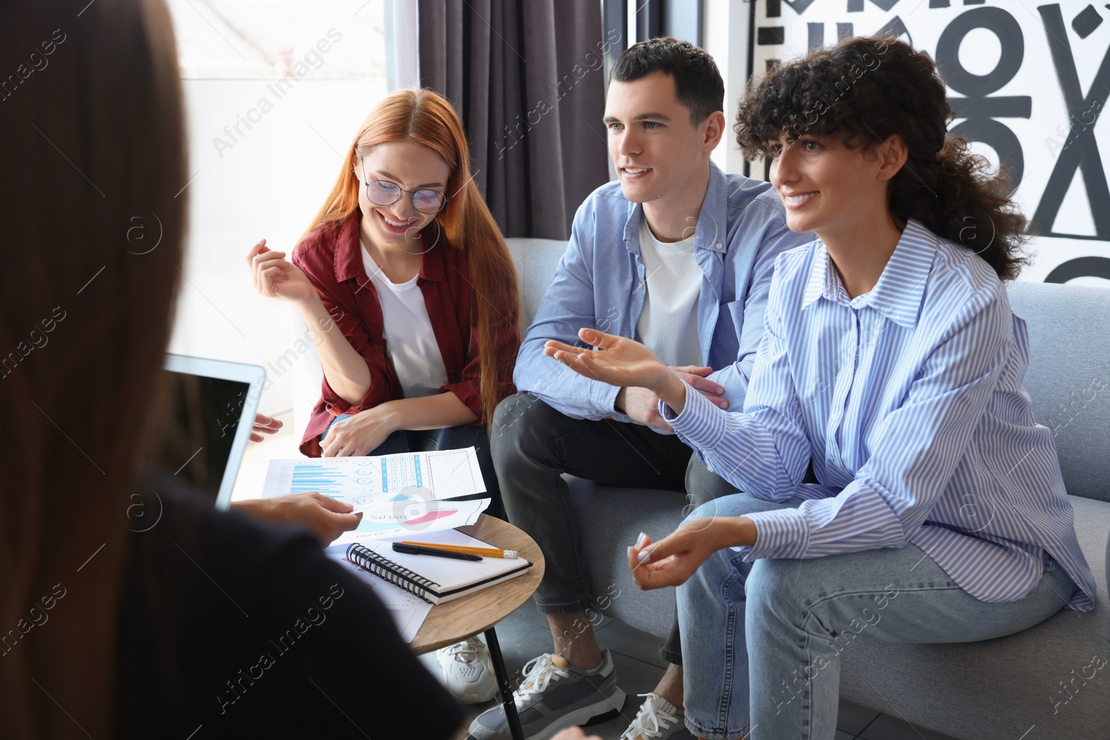 Photo of Team of employees working together in office. Startup project